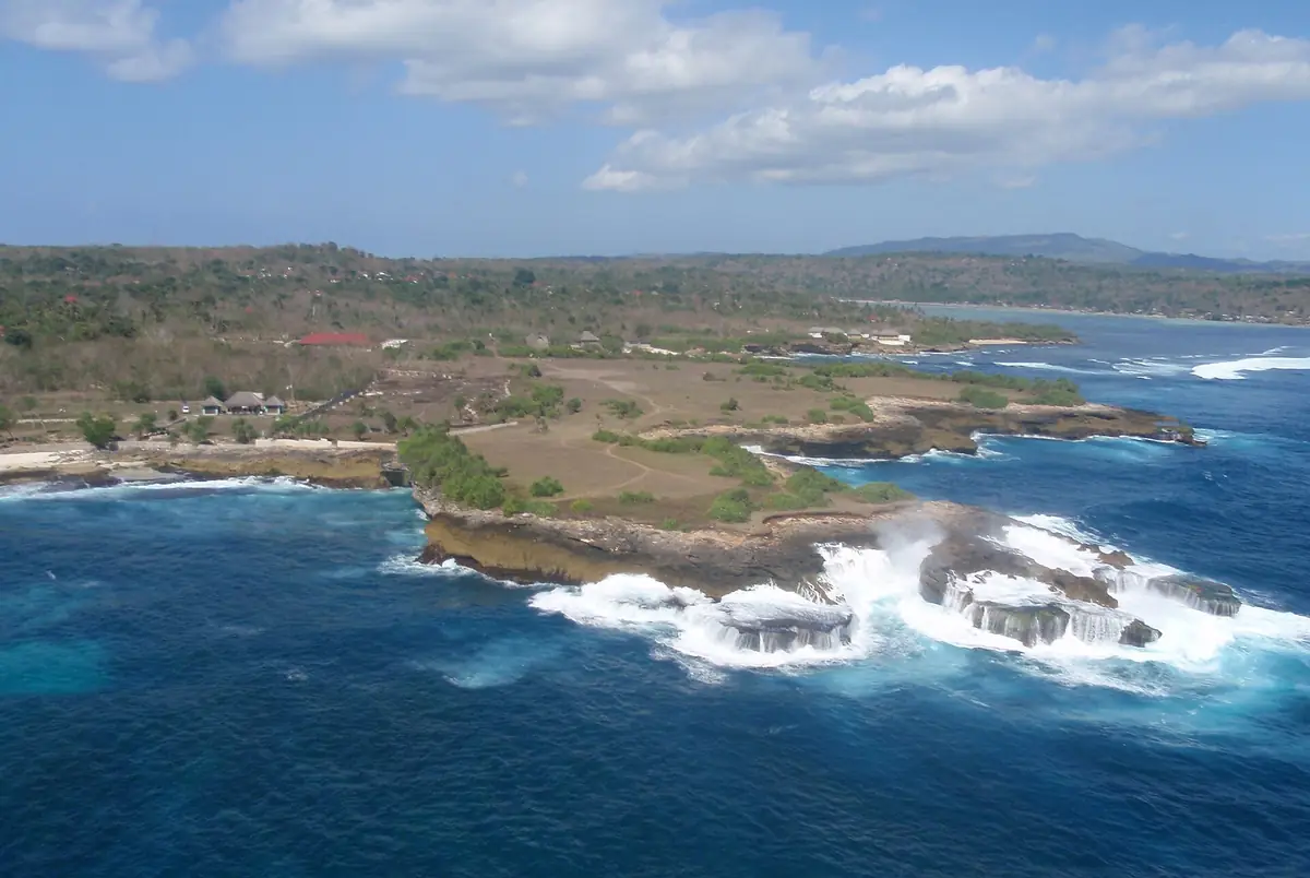 Aerial view of the Nusa Lembongan coastline, waves breaking on the reef